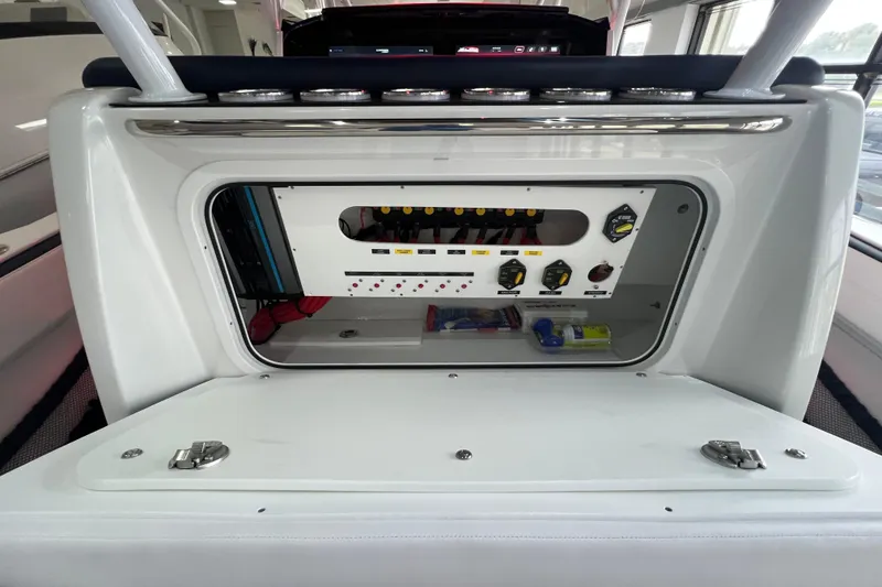 Slide: The Image of 2026 Nor-Tech 340 Sport boat interior with open storage compartment and sleek seating. - 22