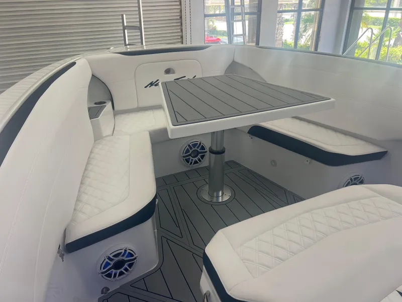 Slide: The Image of 2026 Nor-Tech 340 Sport boat interior with seating and storage, featuring sleek design and modern amenities. - 4