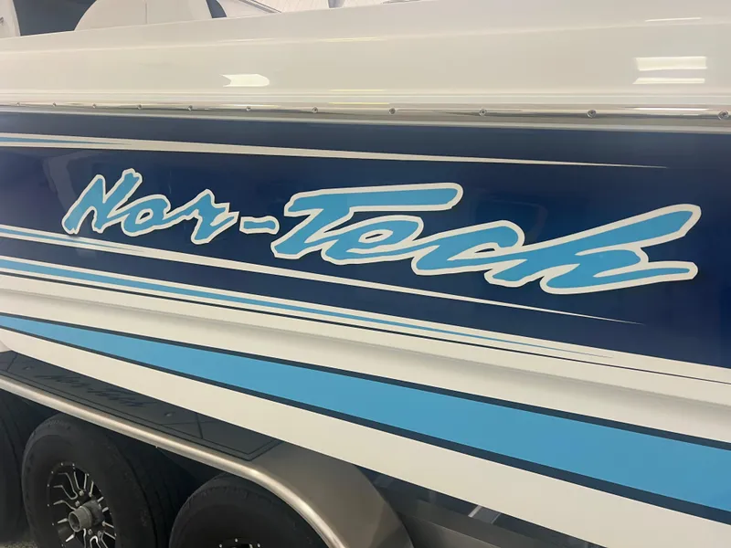 Slide: The Image of 2026 Nor-Tech 340 Sport boat interior with white seating and modern design. - 7