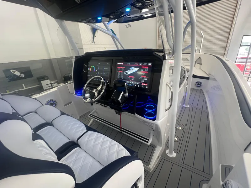 Slide: The Image of Nor-Tech 340 Sport 2026 boat with blue and white design on trailer. - 8