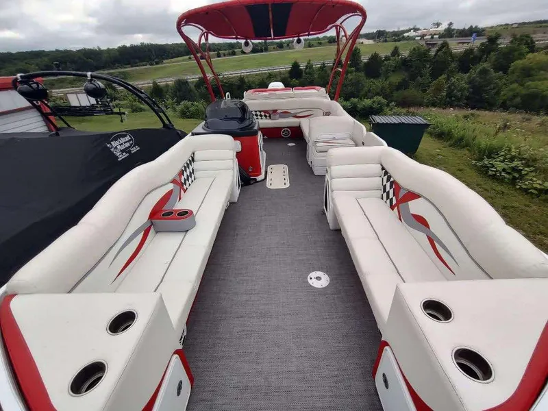 Slide: The Image of 2017 PlayCraft 2600 X-treme boat with spacious seating and stylish red accents. - 1