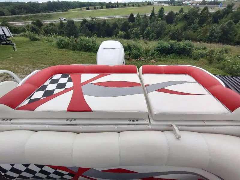 Slide: The Image of 2017 PlayCraft 2600 X-treme boat with red and white seating, scenic background. - 14