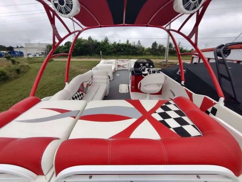 Slide: The Image of 2017 PlayCraft 2600 X-treme boat with red and white seating, outdoor setting. - 15