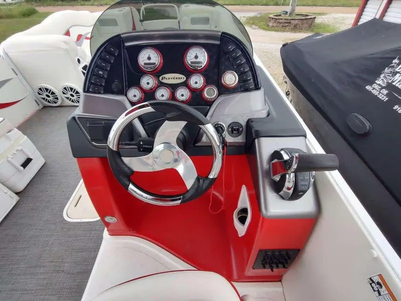 Slide: The Image of 2017 PlayCraft 2600 X-treme boat dashboard with steering wheel and control panel. - 19