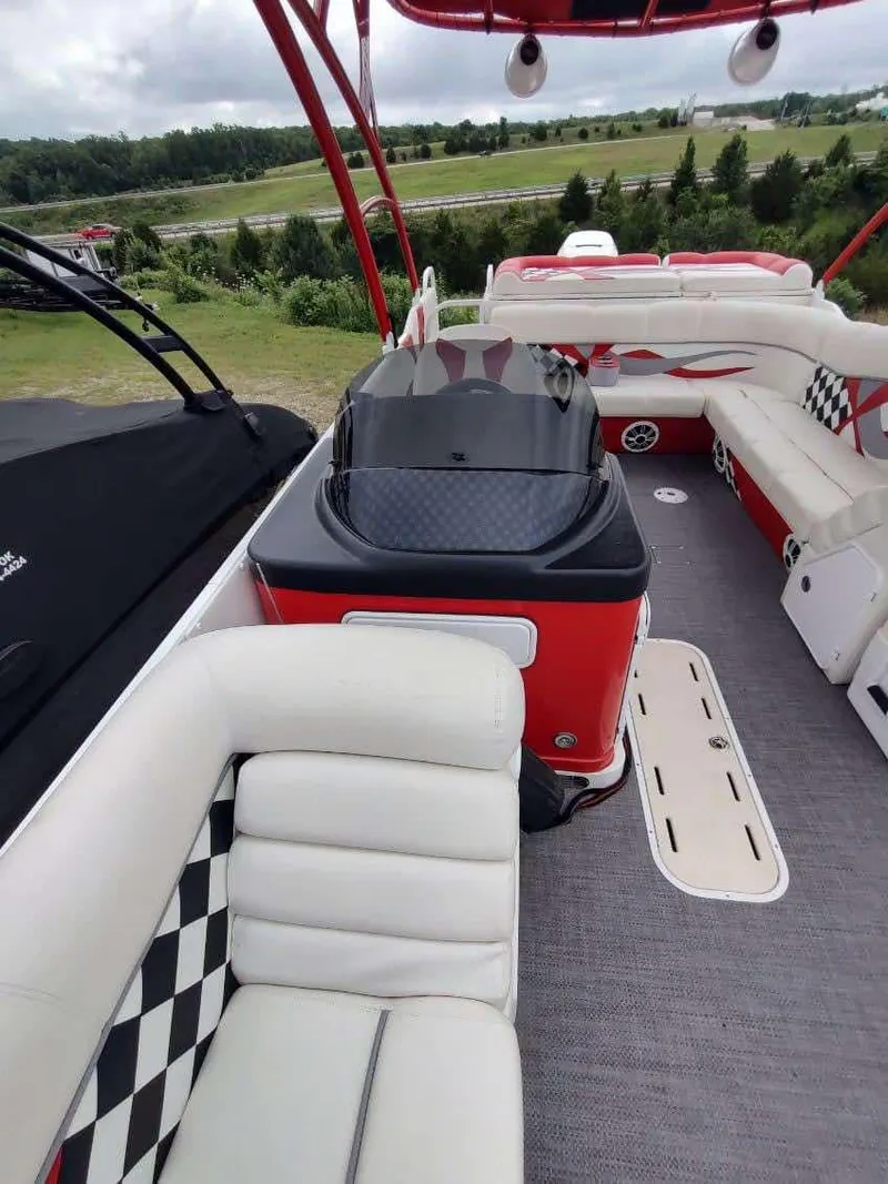 Slide: The Image of 2017 PlayCraft 2600 X-treme boat interior with red and white seating, checkered accents. - 21