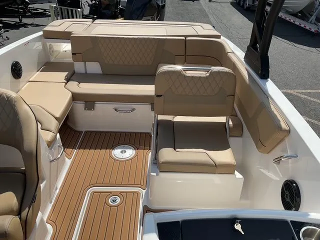 Slide: The Image of 2025 Bayliner VR6 Bowrider OB interior with tan seating and teak-style flooring. - 11