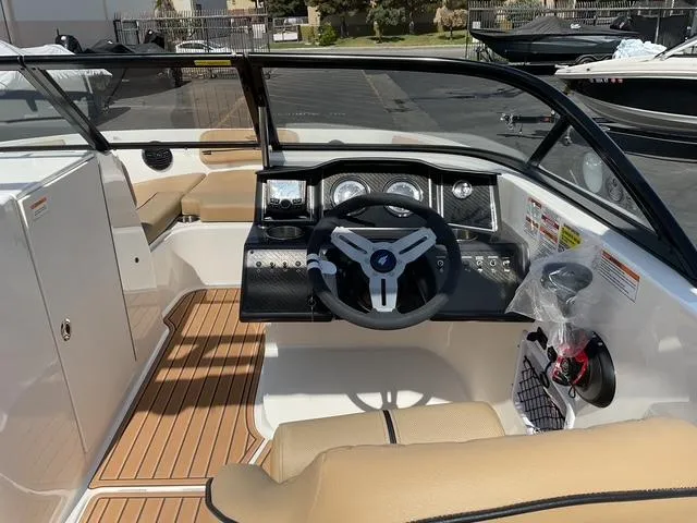 Slide: The Image of 2025 Bayliner VR6 Bowrider OB interior with modern dashboard and steering wheel. - 12