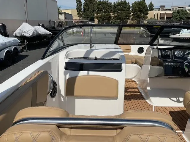Slide: The Image of 2025 Bayliner VR6 Bowrider OB interior with tan seating and sleek dashboard design. - 13