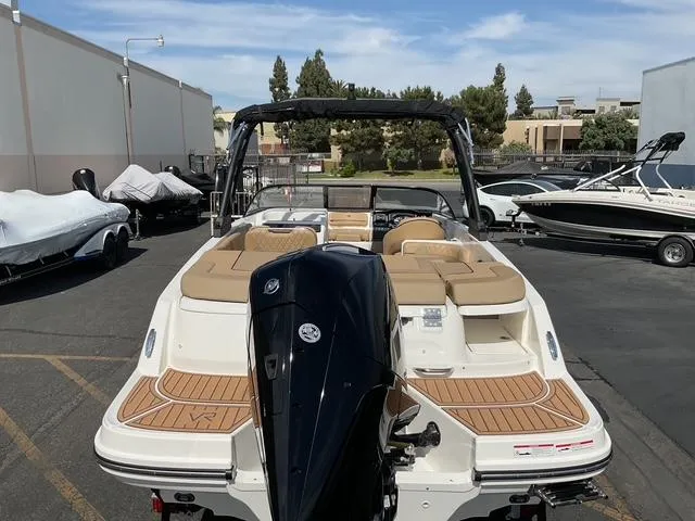 Slide: The Image of 2025 Bayliner VR6 Bowrider OB with outboard motor, parked in a marina lot. - 19