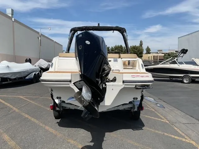 Slide: The Image of 2025 Bayliner VR6 Bowrider OB with outboard motor, parked outdoors on a sunny day. - 6