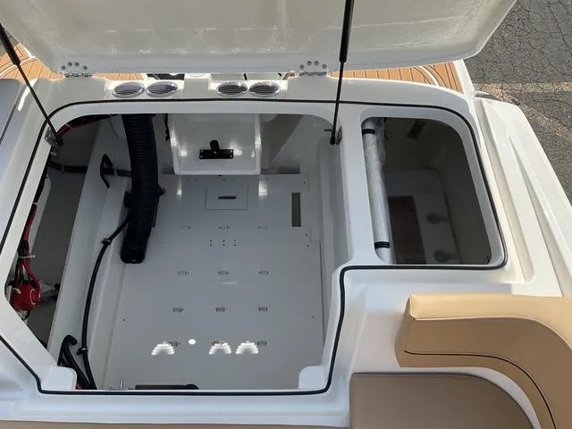 Slide: The Image of 2025 Bayliner VR6 Bowrider OB storage compartment with open hatch, showcasing interior space. - 8