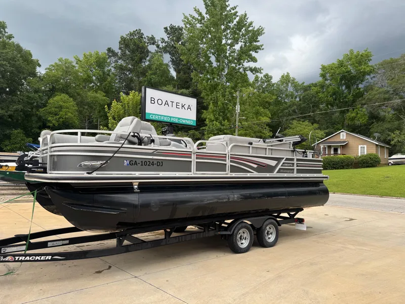 Slide: The Image of 2022 Ranger Reata 223FC pontoon boat on trailer at Boateka dealership. - 2