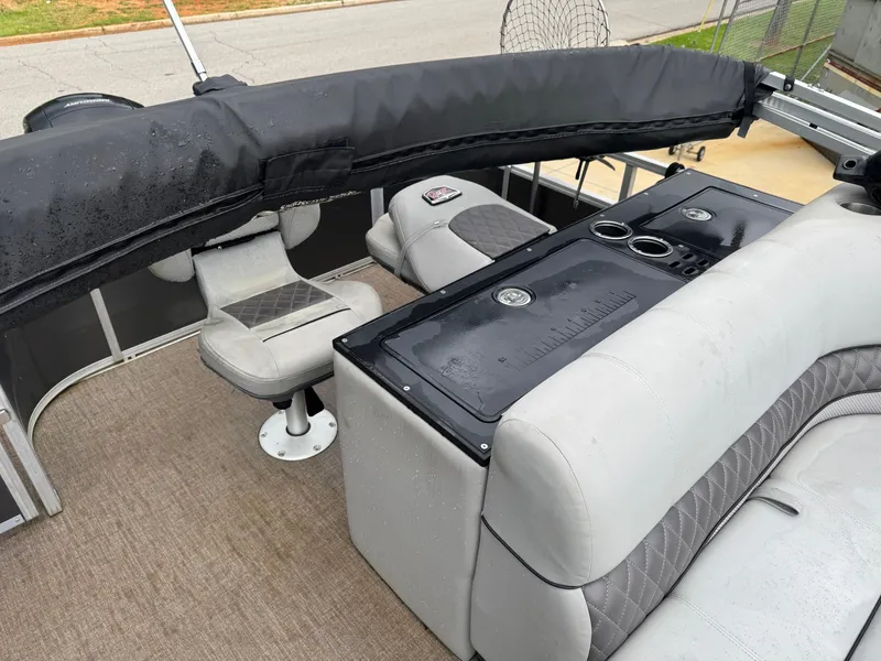 Slide: The Image of 2022 Ranger Reata 223FC boat interior with plush seating and modern dashboard. - 4