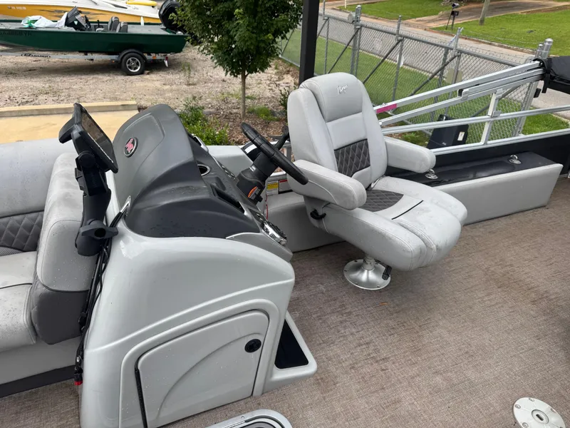 Slide: The Image of 2022 Ranger Reata 223FC boat interior with seating and console, featuring modern design elements. - 5