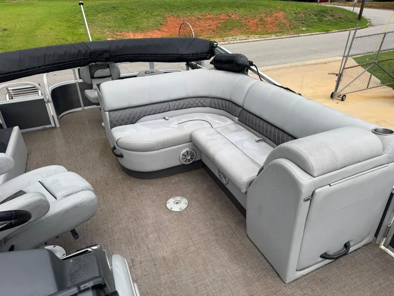 Slide: The Image of 2022 Ranger Reata 223FC boat interior with steering console and seating. - 6