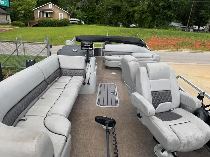 Slide: The Image of 2022 Ranger Reata 223FC pontoon boat with spacious gray seating and carpeted deck. - 7