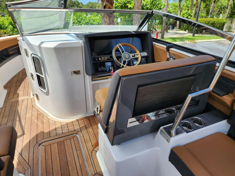 Slide: The Image of 2021 Cobalt A29 boat interior with modern dashboard and wooden flooring. - 11
