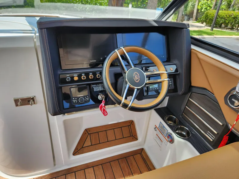 Slide: The Image of 2021 Cobalt A29 boat dashboard with steering wheel and control panel. - 12