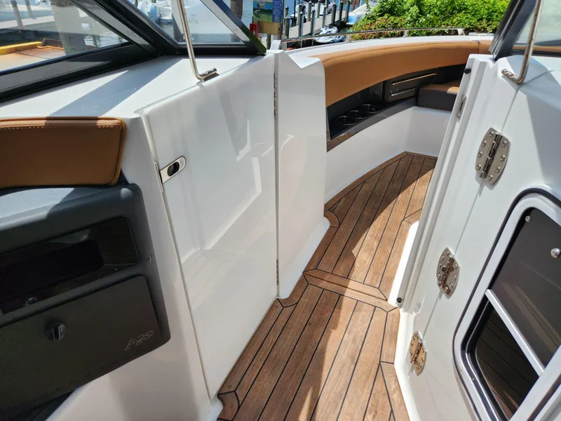 Slide: The Image of 2021 Cobalt A29 boat interior with teak flooring and leather seating. - 14