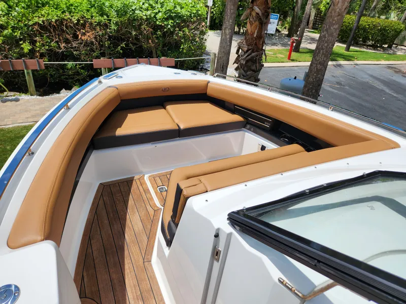 Slide: The Image of 2021 Cobalt A29 boat with tan leather seating and wooden deck. - 15