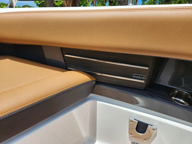 Slide: The Image of 2021 Cobalt A29 boat interior with tan leather seating and speaker detail. - 16