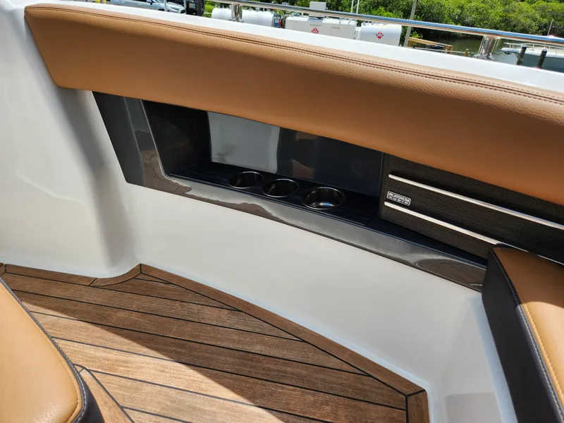 Slide: The Image of Interior of 2021 Cobalt A29 boat with brown seating and wood flooring. - 18