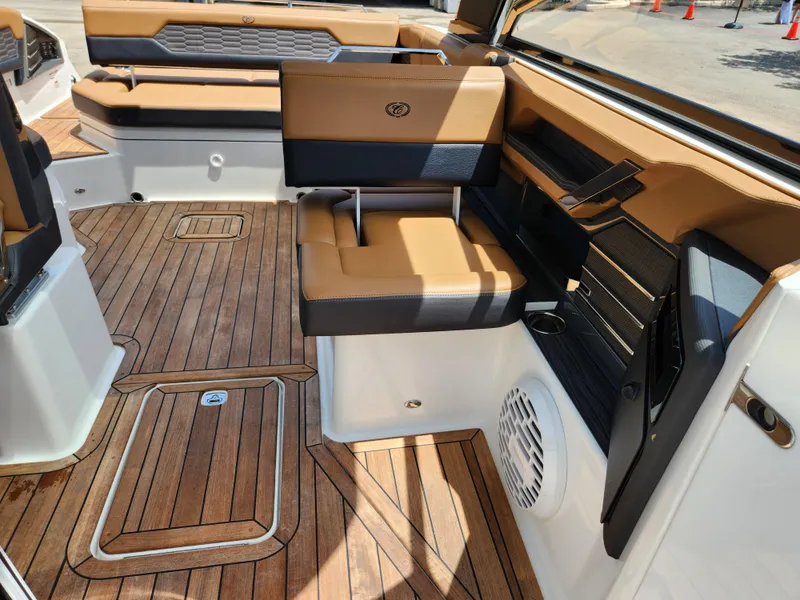 Slide: The Image of 2021 Cobalt A29 boat interior with teak flooring and tan seating. - 19
