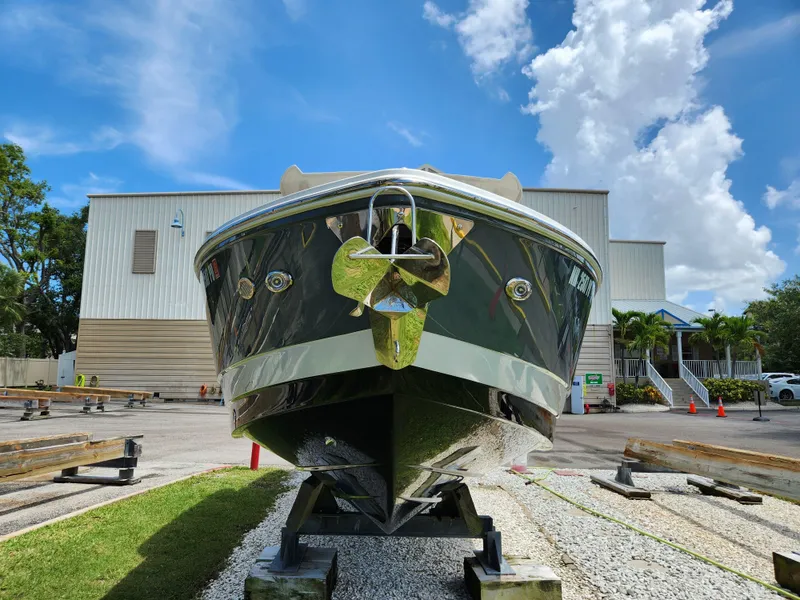 Slide: The Image of 2021 Cobalt A29 boat on display, front view, outdoors, clear sky background. - 2