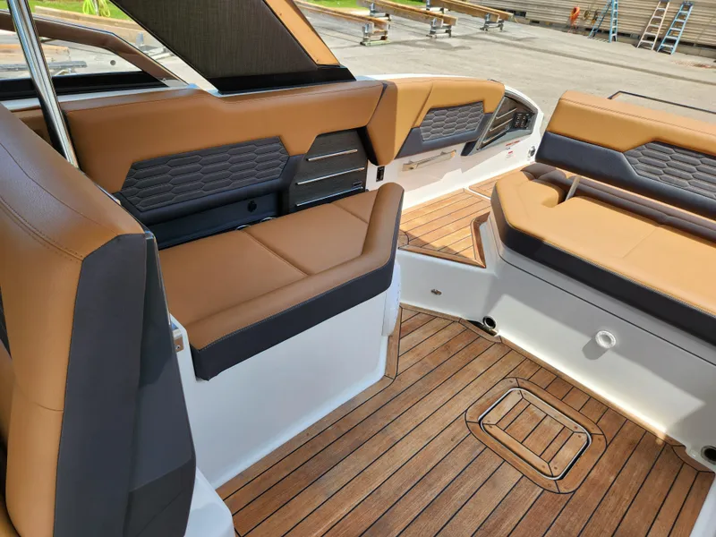 Slide: The Image of 2021 Cobalt A29 boat interior with tan leather seats and wooden flooring. - 21