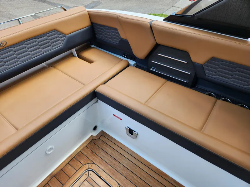 Slide: The Image of Luxurious seating on 2021 Cobalt A29 boat with tan upholstery and wood flooring. - 23