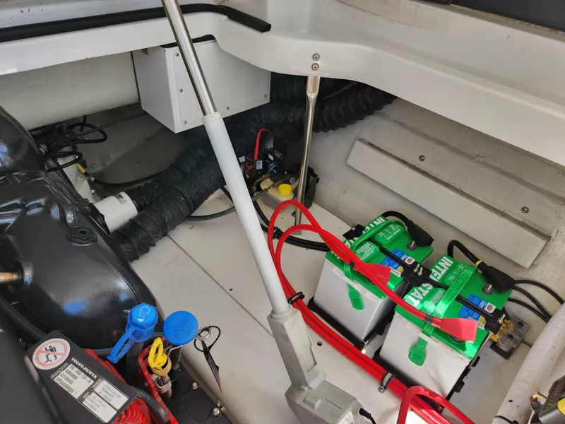Slide: The Image of Engine compartment of a 2021 Cobalt A29 boat with batteries and wiring. - 26
