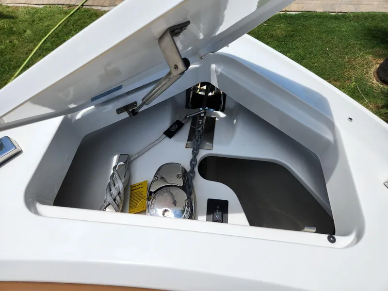 Slide: The Image of Open anchor compartment of 2021 Cobalt A29 boat, showcasing anchor and rope storage. - 27