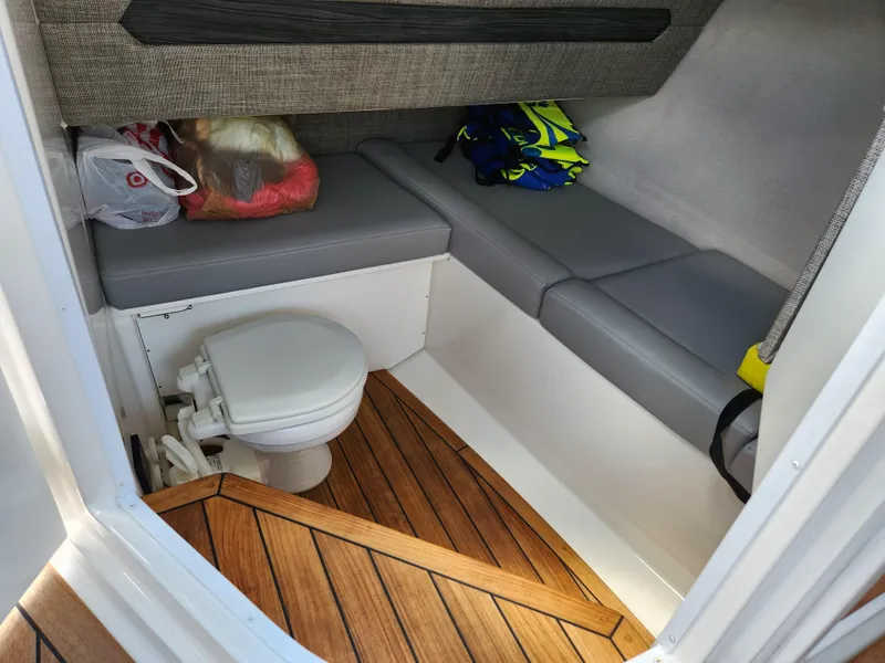 Slide: The Image of 2021 Cobalt A29 cabin interior with toilet, seating, and wood flooring. - 28