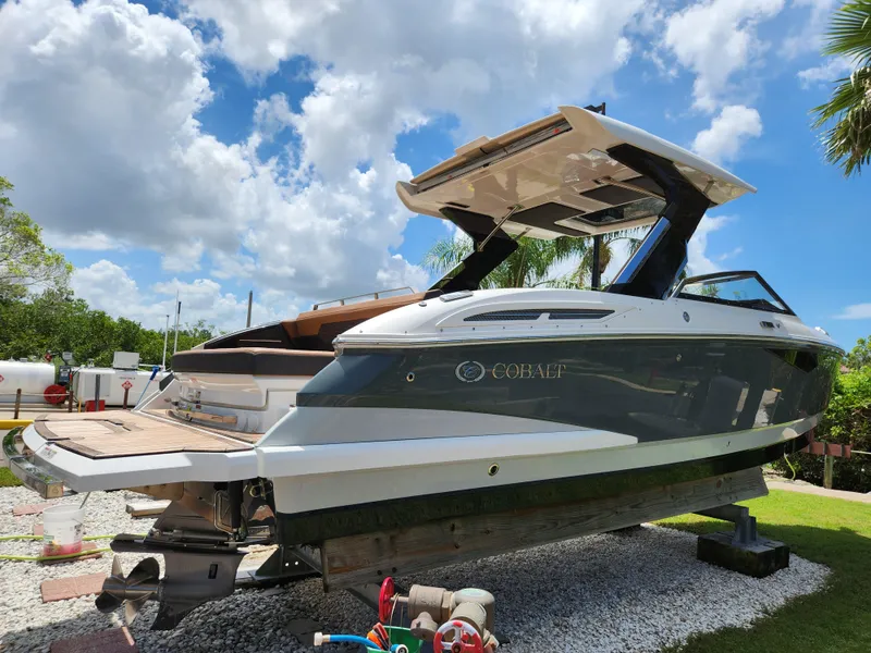 Slide: The Image of 2021 Cobalt A29 boat on display under a bright blue sky. - 3