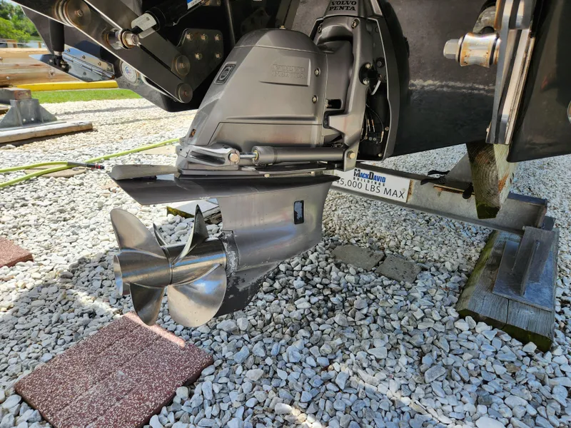 Slide: The Image of 2021 Cobalt A29 boat propeller and drive system on gravel surface. - 31