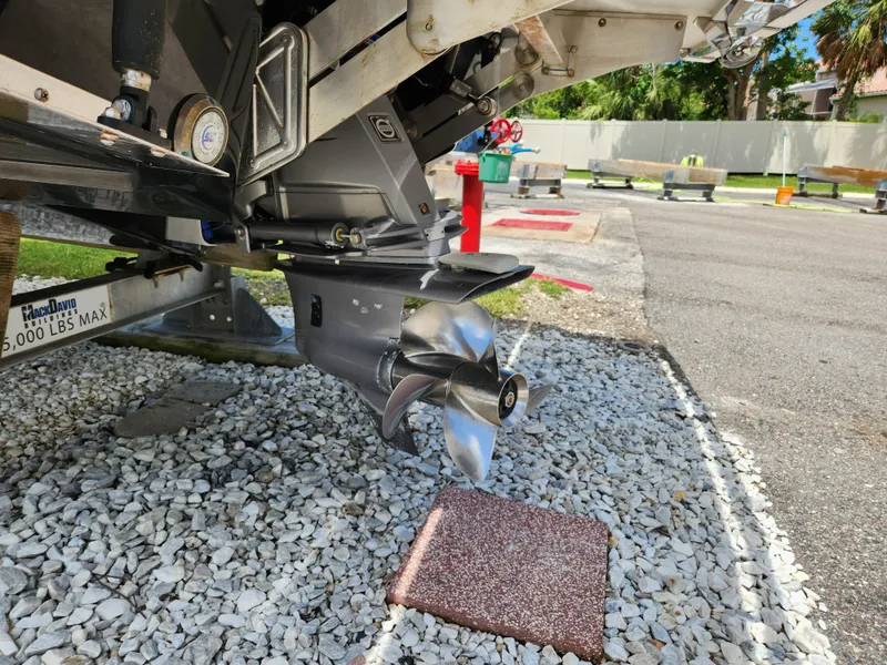 Slide: The Image of 2021 Cobalt A29 boat propeller on a trailer, parked on gravel. - 32