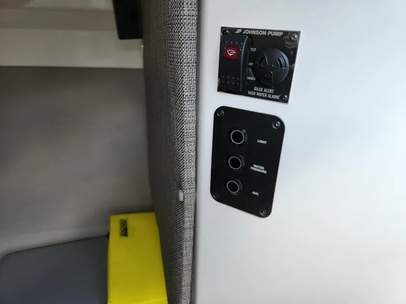 Slide: The Image of 2021 Cobalt A29 boat interior control panel with switches and Johnson pump. - 34