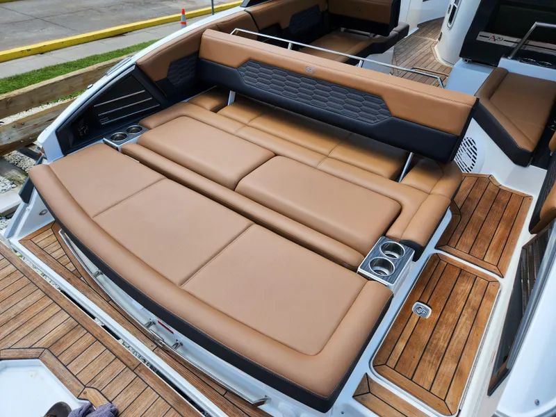 Slide: The Image of 2021 Cobalt A29 boat with luxurious tan leather seating and wooden deck accents. - 7