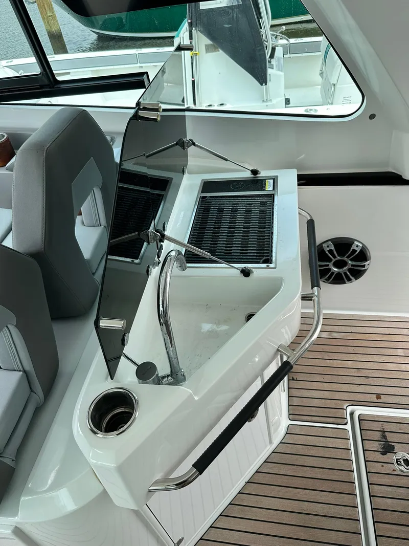 Slide: The Image of 2021 Beneteau GT 32 boat interior with sleek seating and modern controls. - 22