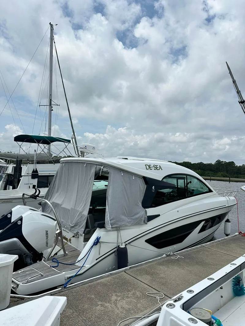 Slide: The Image of 2021 Beneteau GT 32 yacht docked at marina under cloudy sky. - 3