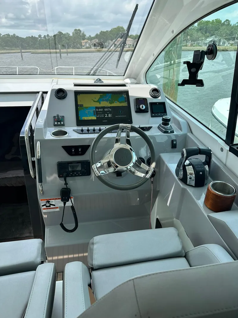 Slide: The Image of 2021 Beneteau GT 32 helm with modern controls and navigation system. - 32