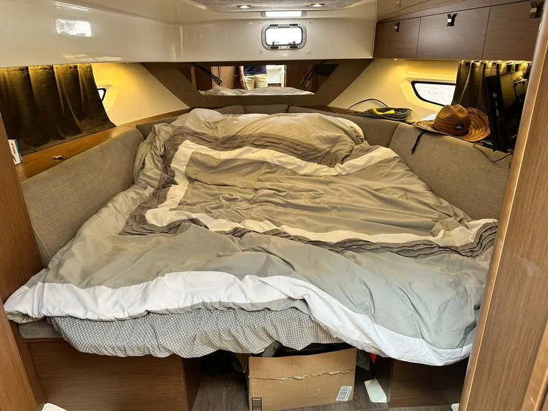 Slide: The Image of Cozy cabin interior of 2021 Beneteau GT 32 with comfortable bedding and ambient lighting. - 47