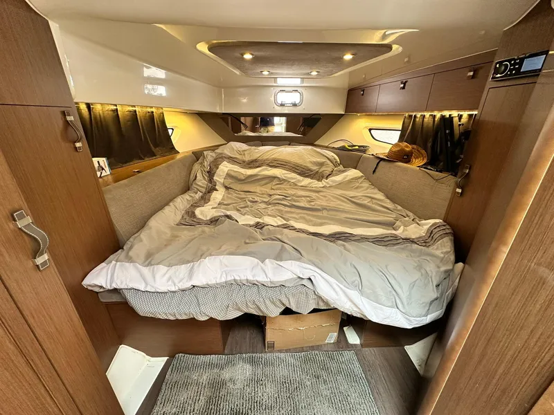 Slide: The Image of Interior cabin of 2021 Beneteau GT 32 with cozy bed and wooden finish. - 48