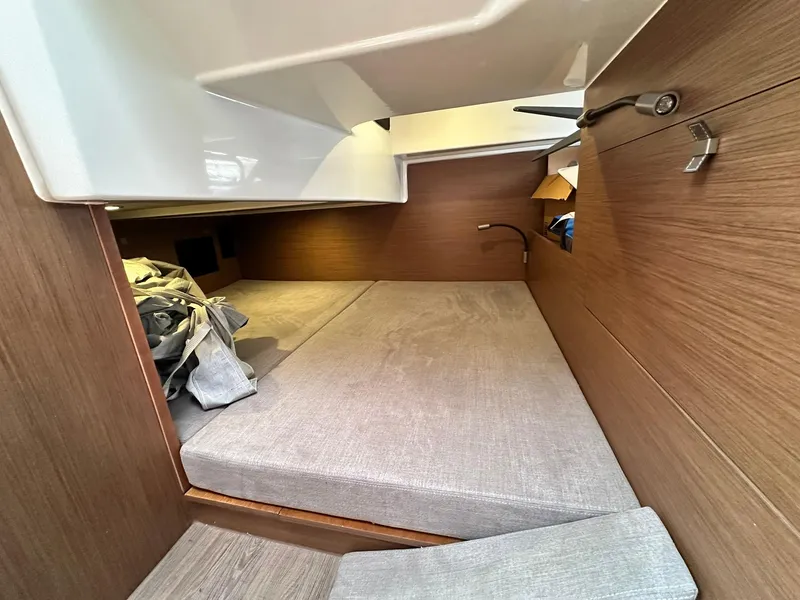 Slide: The Image of 2021 Beneteau GT 32 cabin interior with cozy sleeping area and wooden finish. - 49