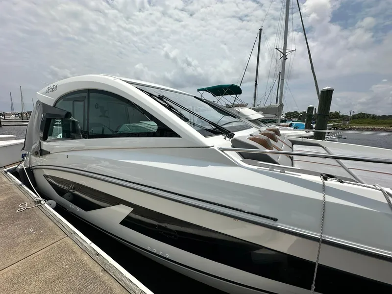 Slide: The Image of 2021 Beneteau GT 32 yacht docked at marina under cloudy sky. - 8