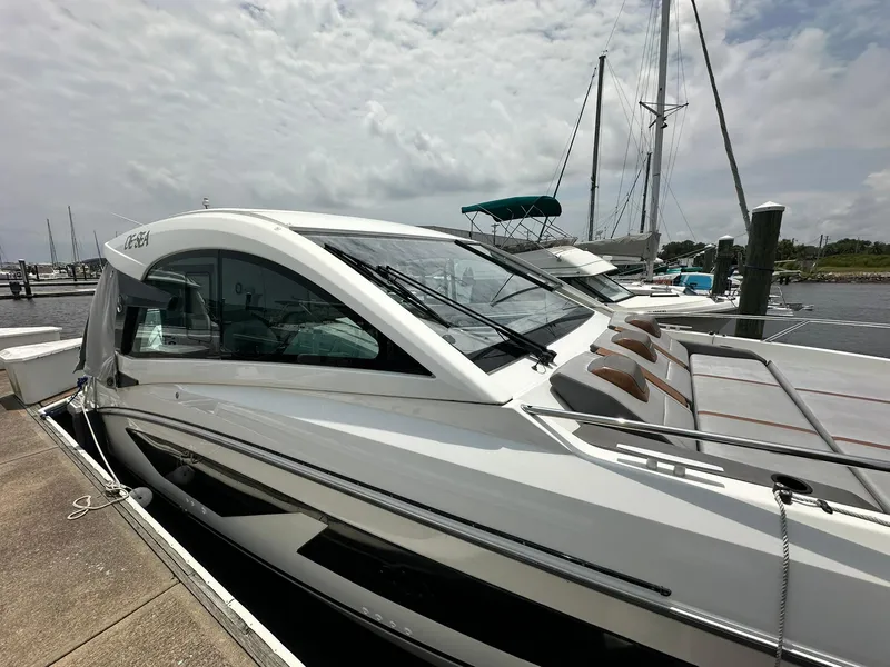 Slide: The Image of 2021 Beneteau GT 32 yacht docked at marina under cloudy sky. - 9