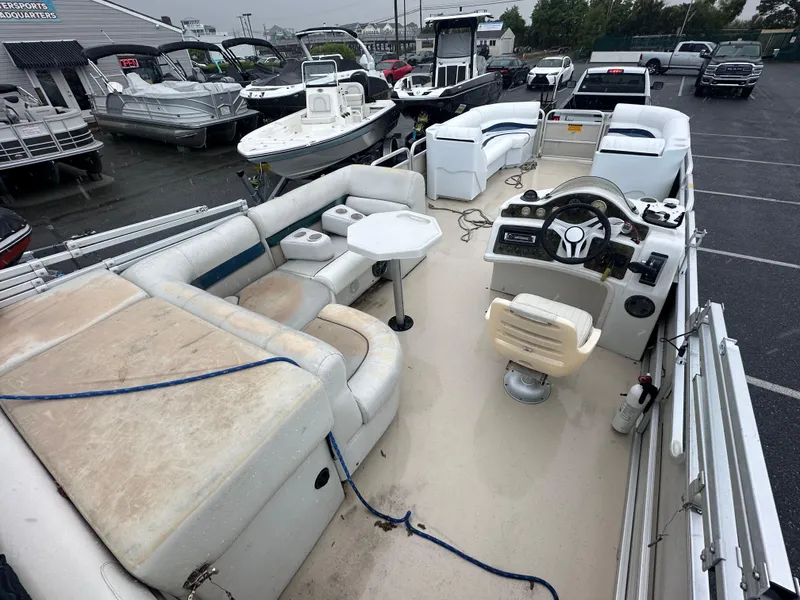 Slide: The Image of 2003 AquaPatio 240 RE pontoon boat with spacious seating and steering console. - 11