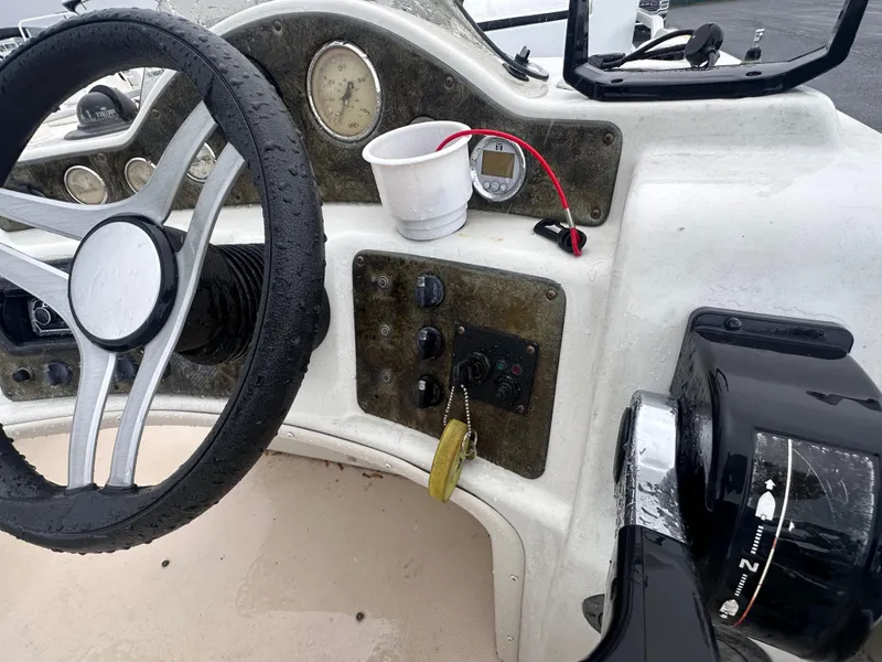 Slide: The Image of Steering console of 2003 AquaPatio 240 RE boat with controls and gauges. - 14