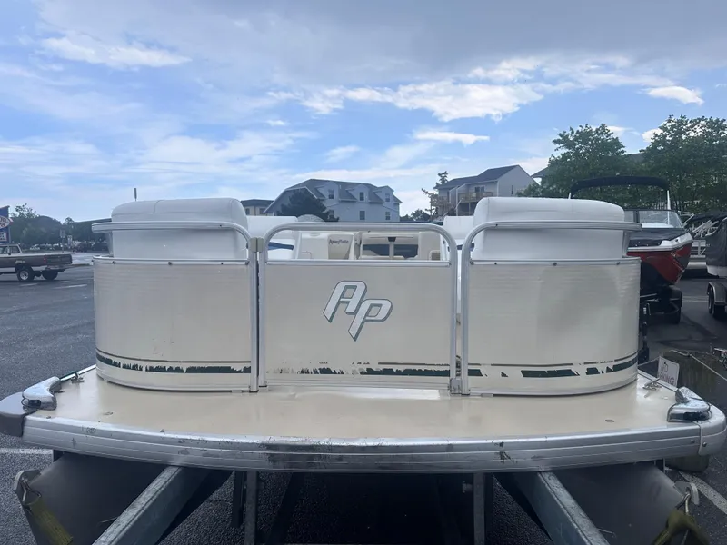 Slide: The Image of 2003 AquaPatio 240 RE pontoon boat on trailer, parked outdoors under cloudy sky. - 3