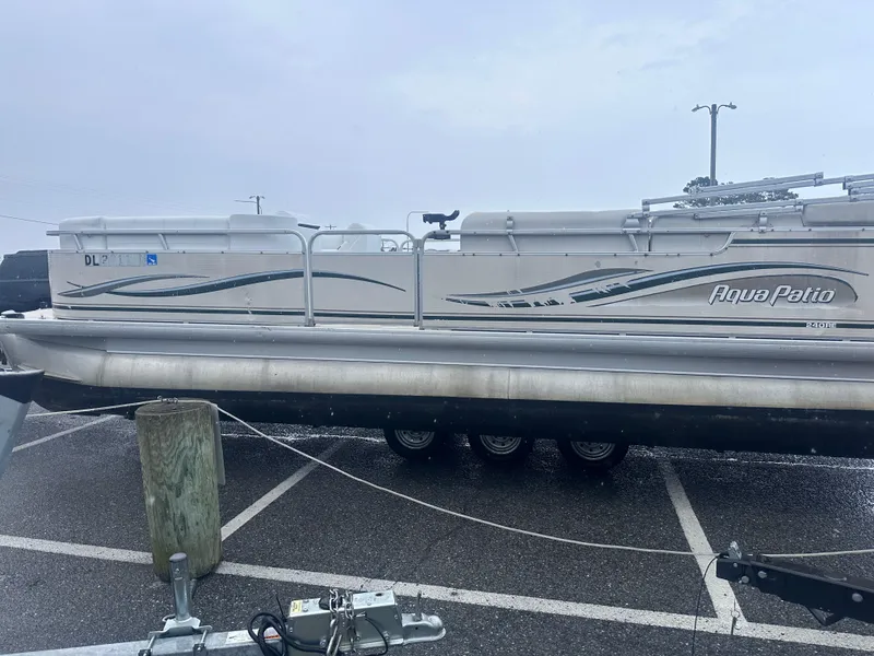 Slide: The Image of 2003 AquaPatio 240 RE pontoon boat parked in a lot on a trailer. - 5